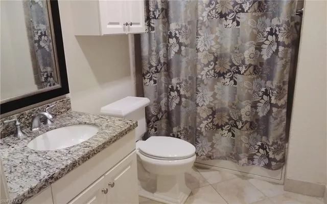 a bedroom with a bed and a black gate