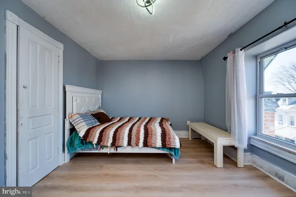 a bedroom with a bed and window
