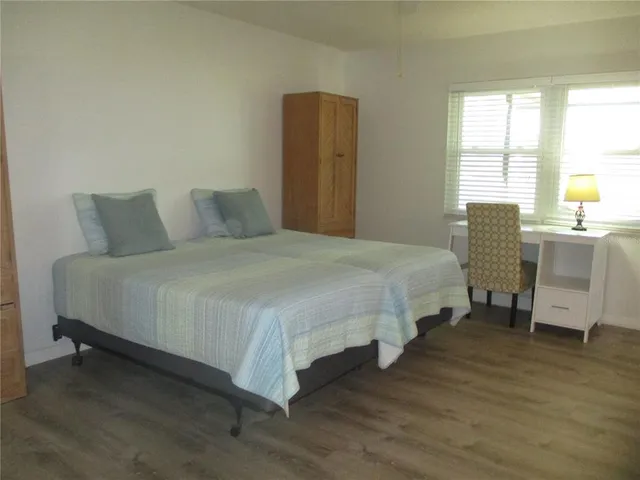 a bathroom with a granite countertop toilet sink and mirror