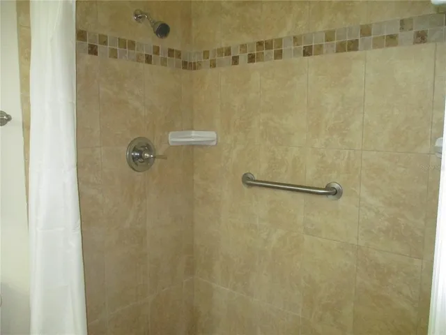 a spacious bedroom with a bed and a window