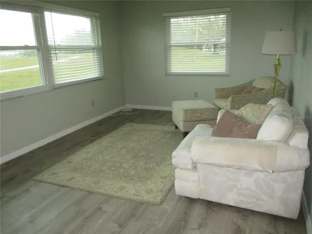 a bedroom with bed and wooden floor