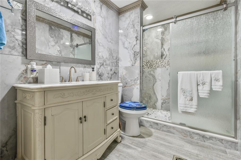 591 Rue Cezzan Lavonia, GA 30553 - Photo 14 of 36 a bathroom with a sink toilet and shower