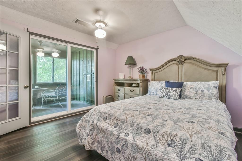 591 Rue Cezzan Lavonia, GA 30553 - Photo 16 of 36 a bedroom with a bed and large window