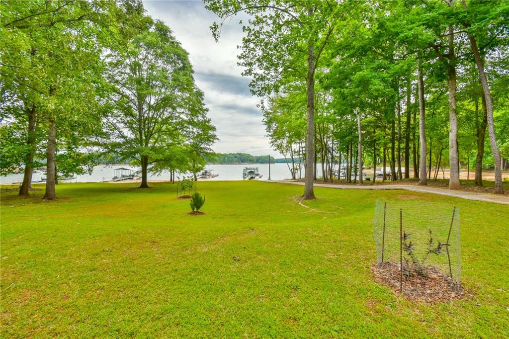 591 Rue Cezzan Lavonia, GA 30553 - Photo 29 of 36 a view of a swimming pool with an outdoor space and seating area