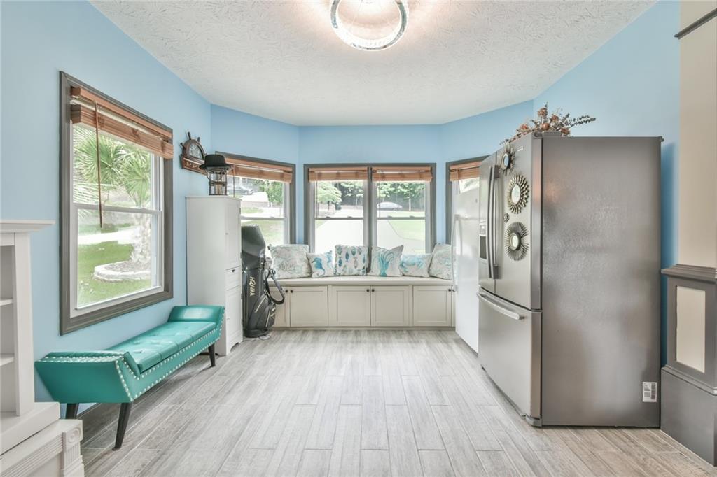 591 Rue Cezzan Lavonia, GA 30553 - Photo 6 of 36 a kitchen with a wooden floor and a large window