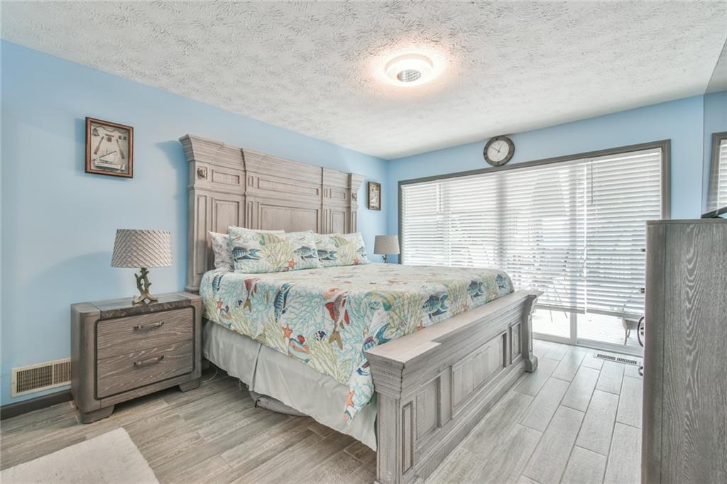 591 Rue Cezzan Lavonia, GA 30553 - Photo 10 of 36 a bedroom with a bed and a night stand