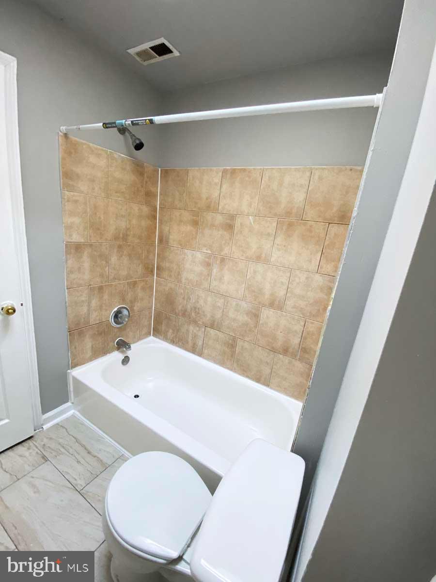 3015 Rayner Avenue Baltimore, MD 21216 - Photo 12 of 71 a bathroom with a bathtub and a toilet