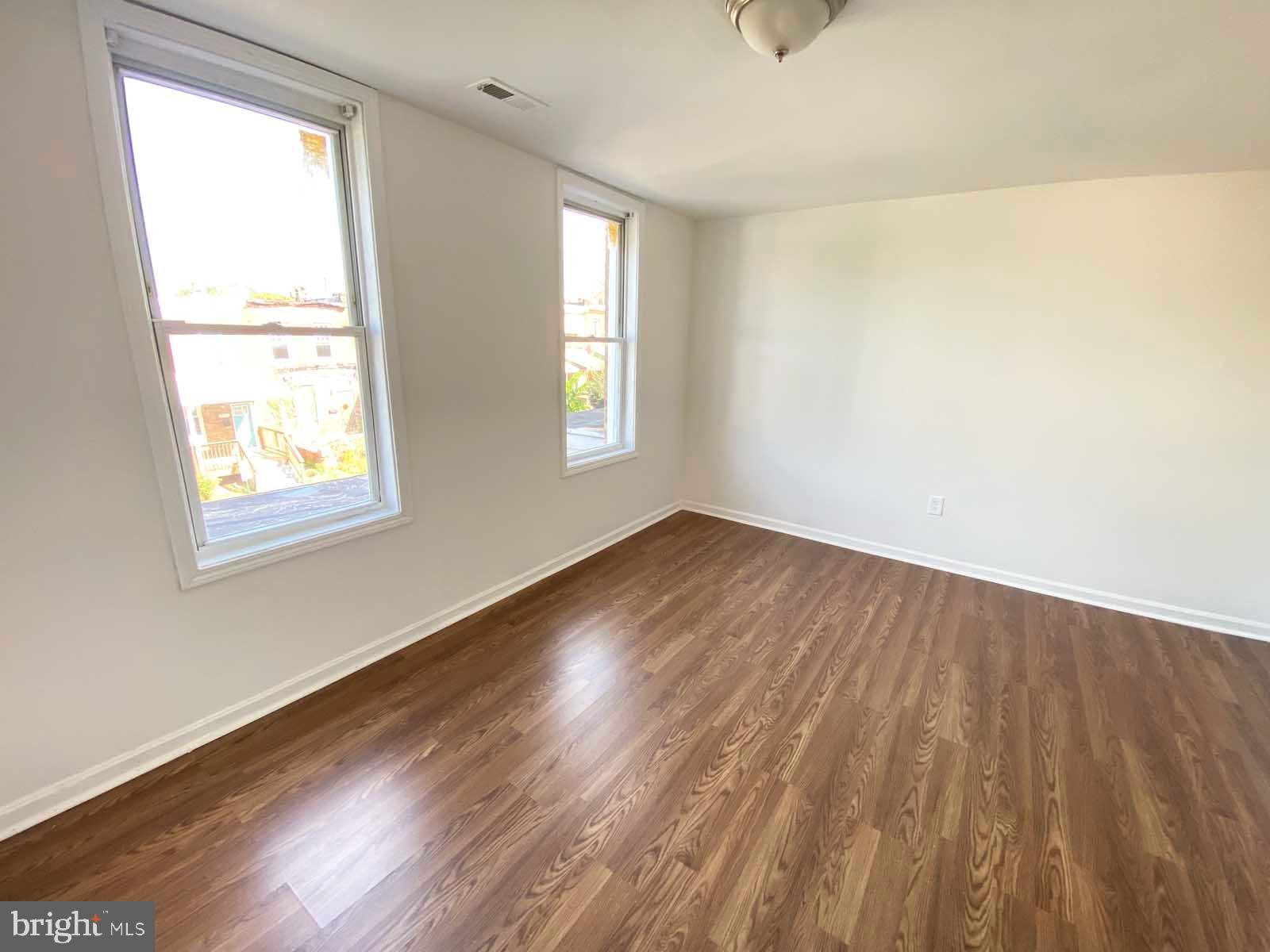 3015 Rayner Avenue Baltimore, MD 21216 - Photo 18 of 71 a view of an empty room and wooden floor