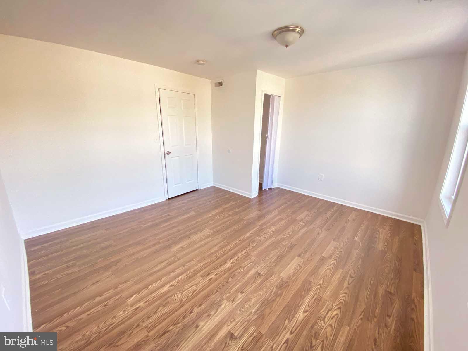 3015 Rayner Avenue Baltimore, MD 21216 - Photo 19 of 71 a view of empty room with wooden floor