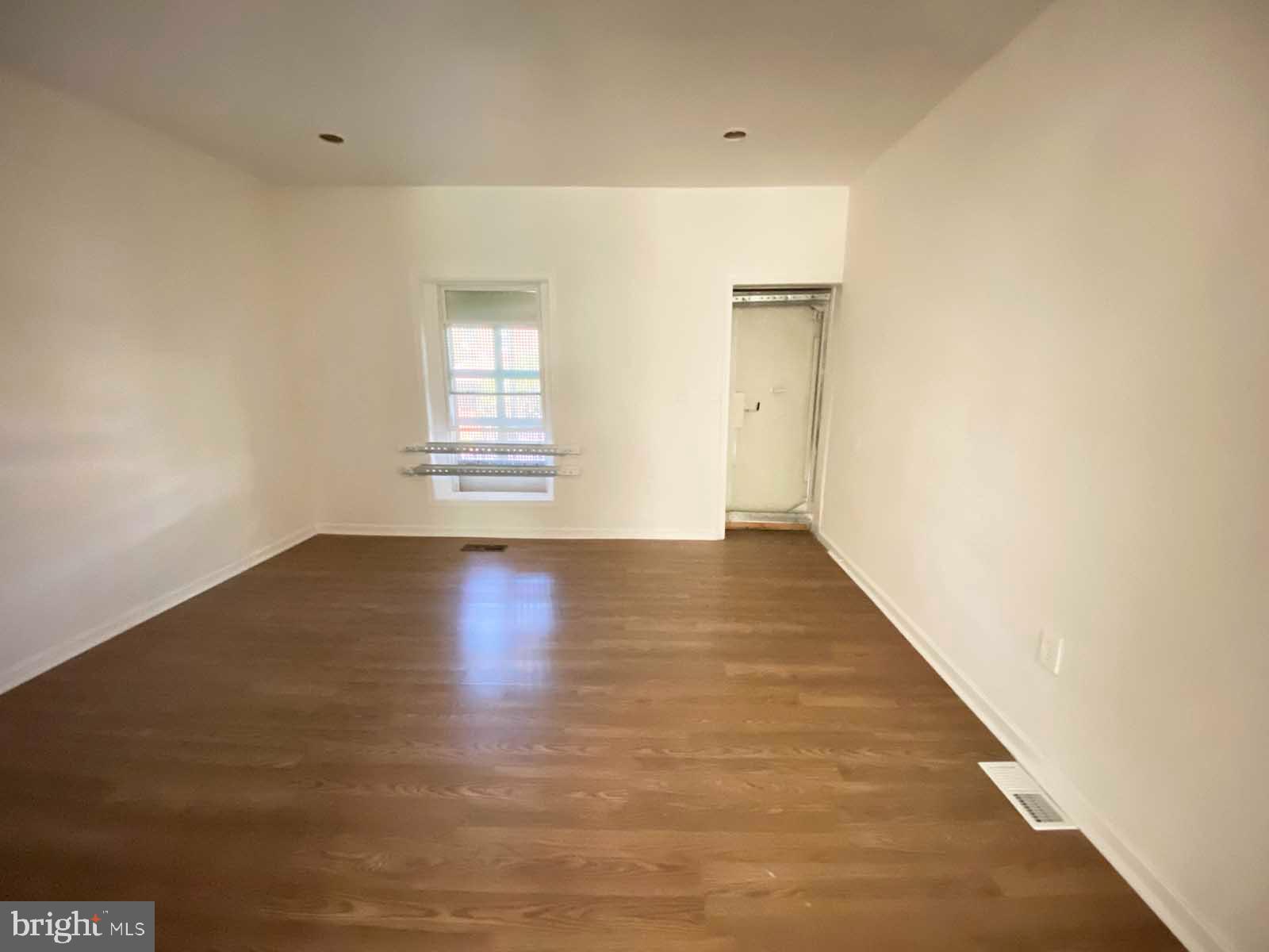 3015 Rayner Avenue Baltimore, MD 21216 - Photo 25 of 71 an empty room with wooden floor and windows