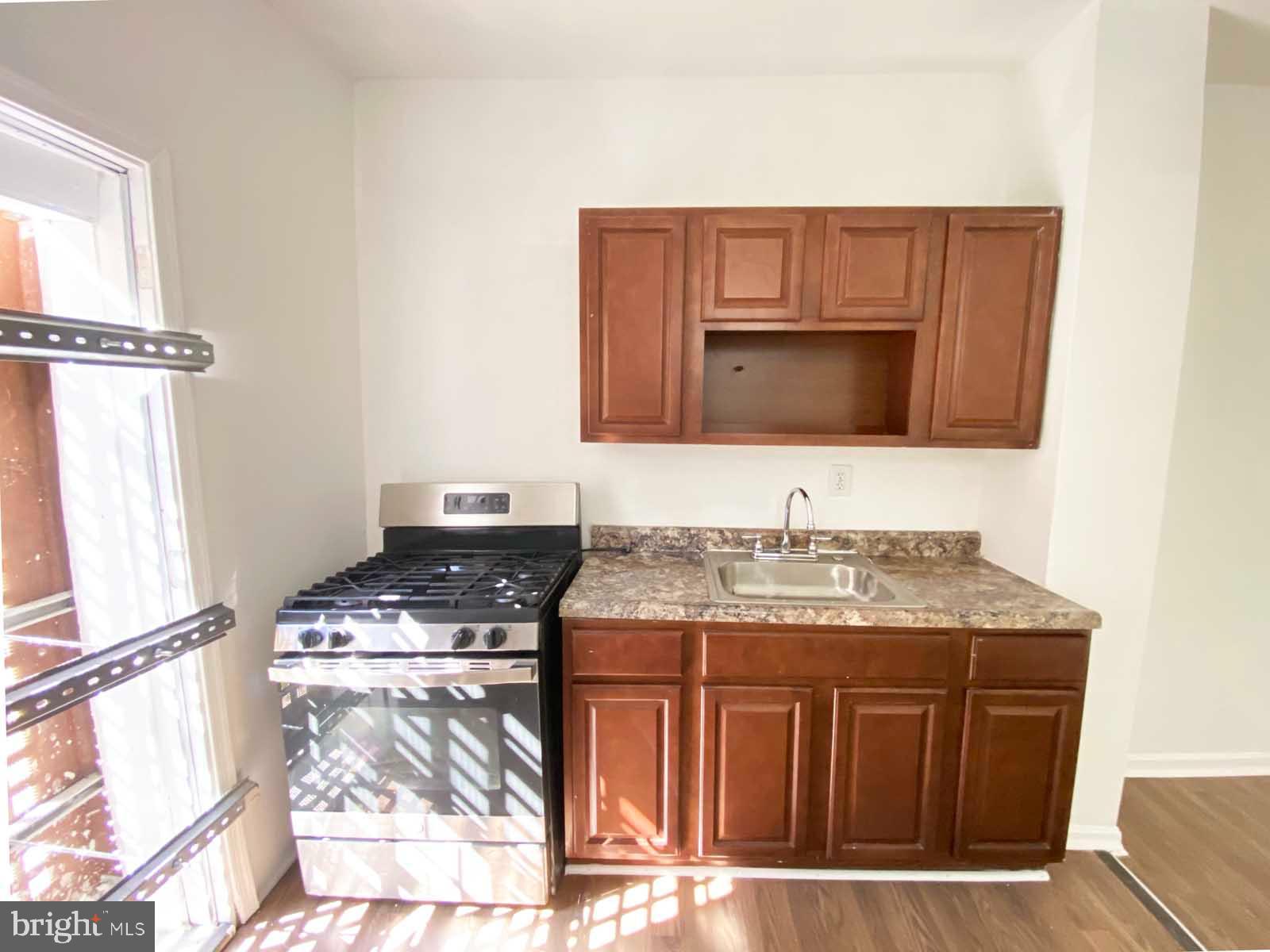 3015 Rayner Avenue Baltimore, MD 21216 - Photo 34 of 71 a kitchen with stainless steel appliances granite countertop a stove and a microwave
