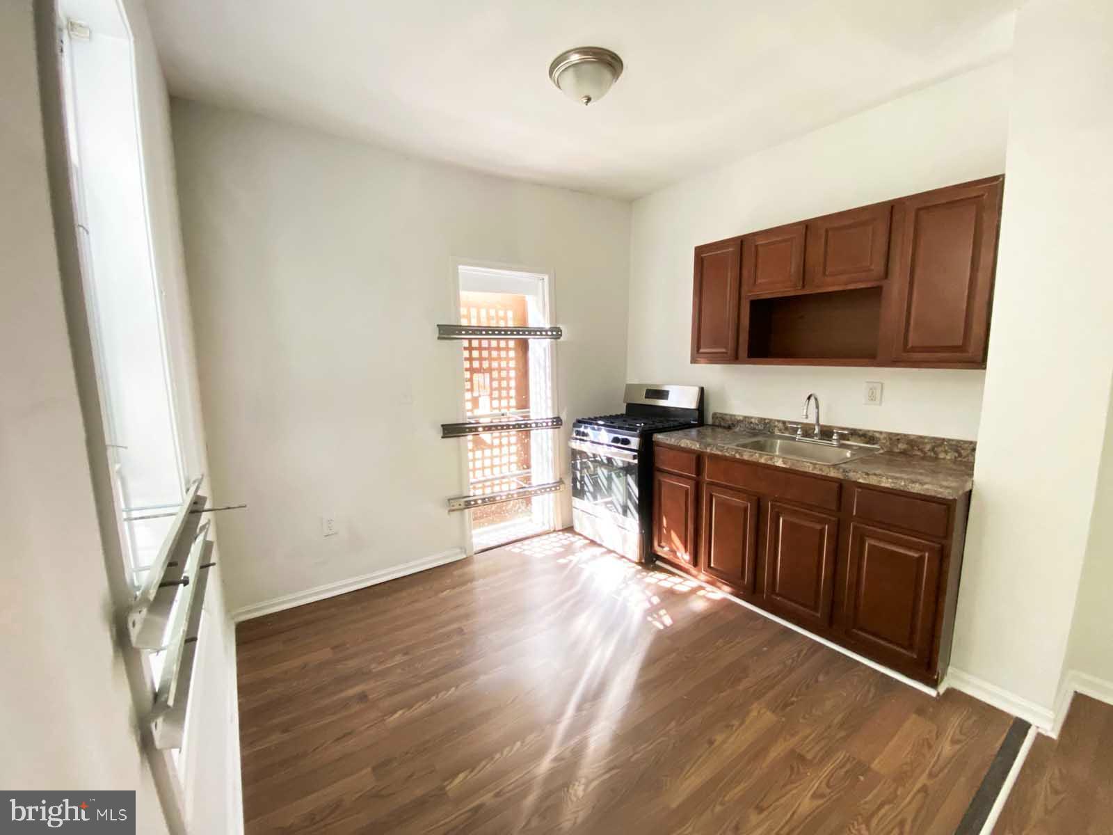 3015 Rayner Avenue Baltimore, MD 21216 - Photo 36 of 71 a kitchen with stainless steel appliances granite countertop a stove a sink and a refrigerator