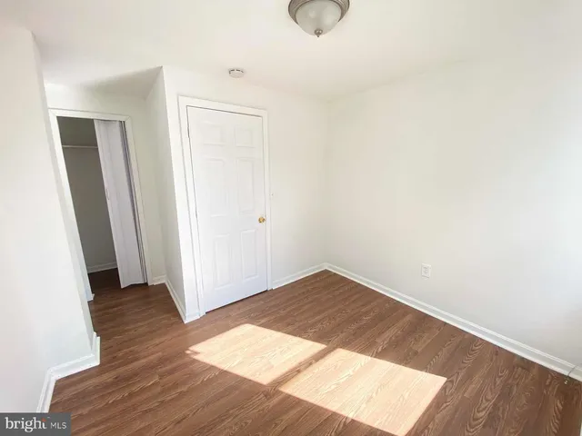 an empty room with wooden floor