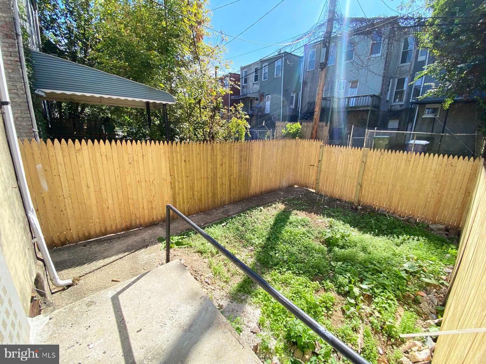 3015 Rayner Avenue Baltimore, MD 21216 - Photo 52 of 71 a view of a backyard with a wooden fence