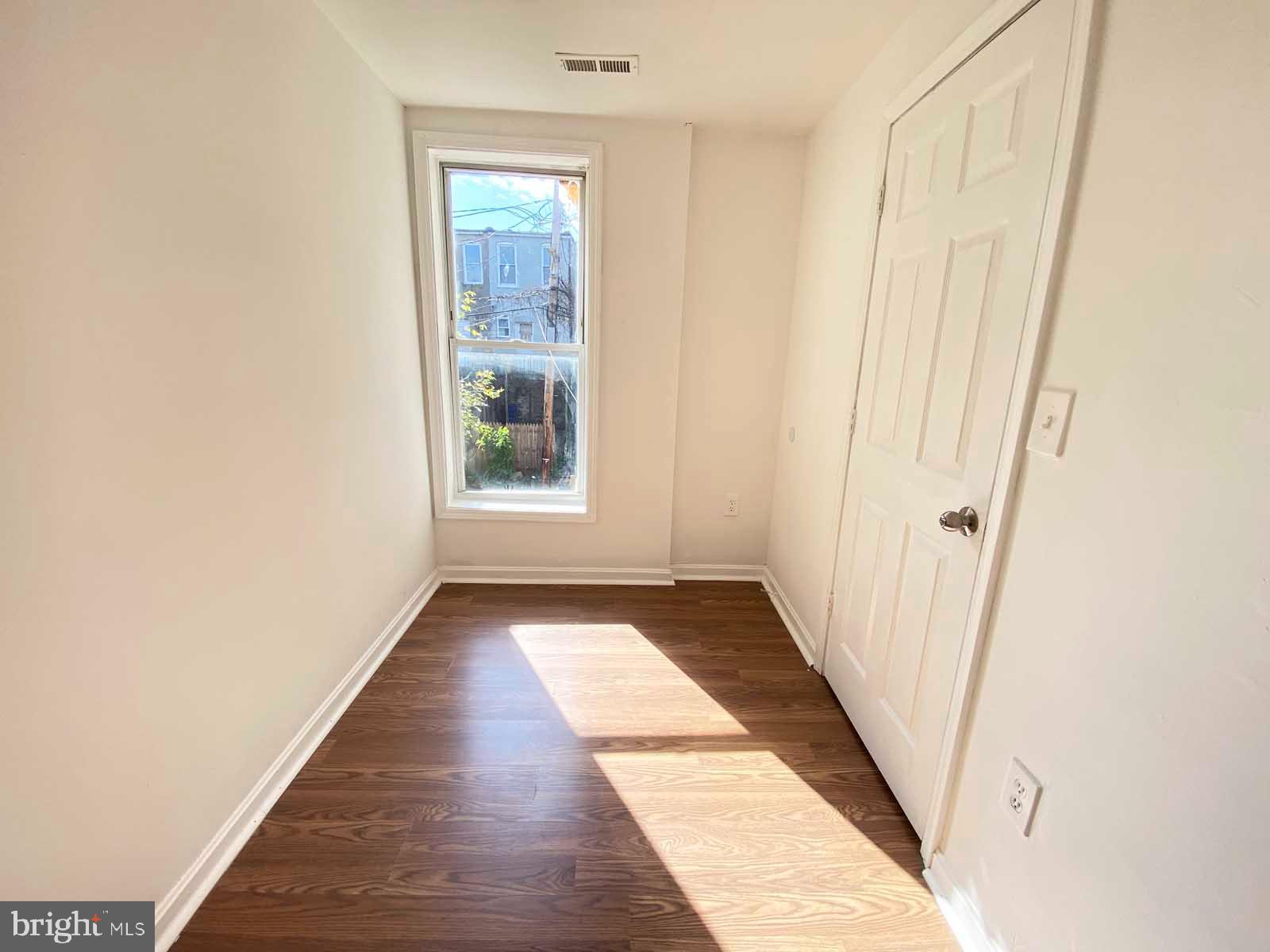 3015 Rayner Avenue Baltimore, MD 21216 - Photo 9 of 71 a view of a hallway with wooden floor and a window