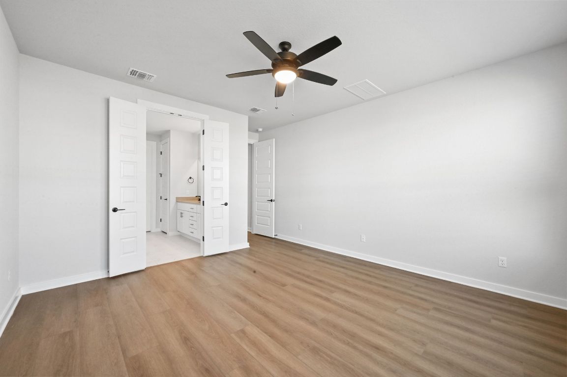 144 Granit Oak Drive Dripping Springs, TX 78620 - Photo 12 of 33 wooden floor in an empty room