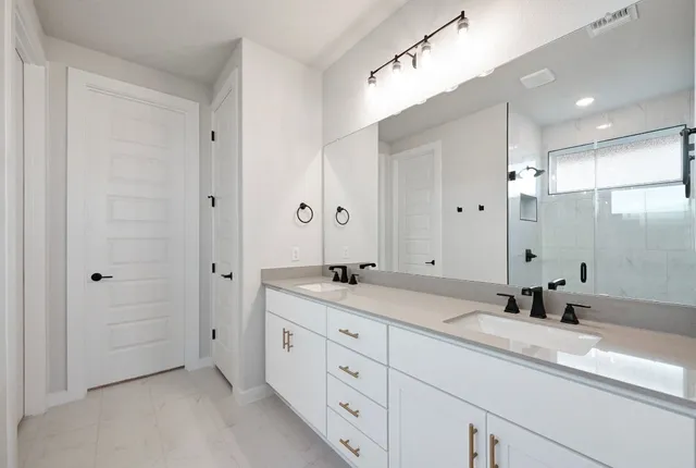 a bathroom with a granite countertop sink mirror and double