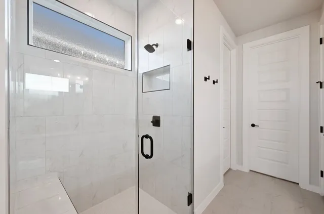 a bathroom with a glass shower door