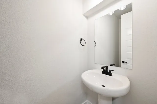 a bathroom with a sink and mirror