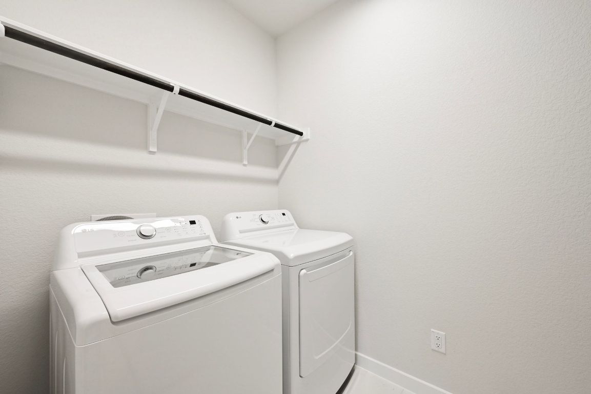 144 Granit Oak Drive Dripping Springs, TX 78620 - Photo 17 of 33 a utility room with dryer and washer