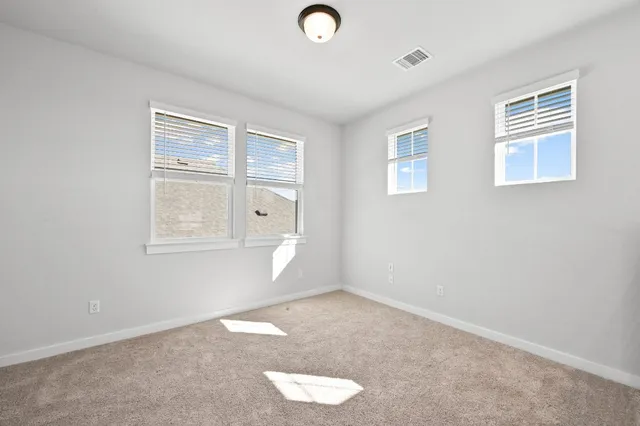 an empty room with windows and closet