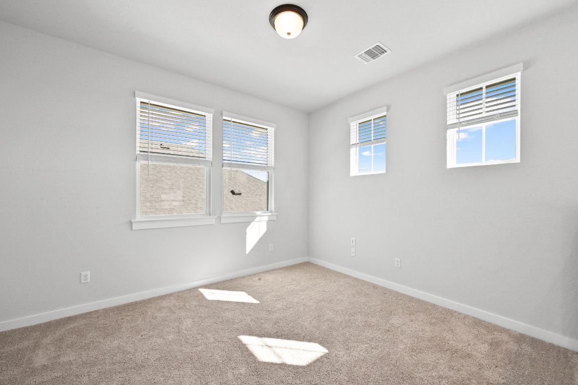 144 Granit Oak Drive Dripping Springs, TX 78620 - Photo 18 of 33 an empty room with windows and closet