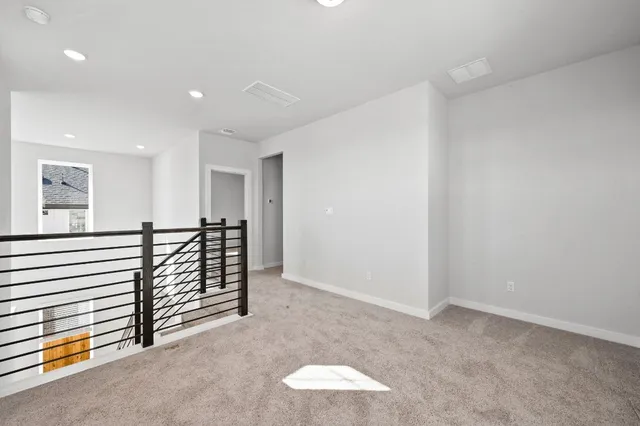 a view of a livingroom with furniture and staircase