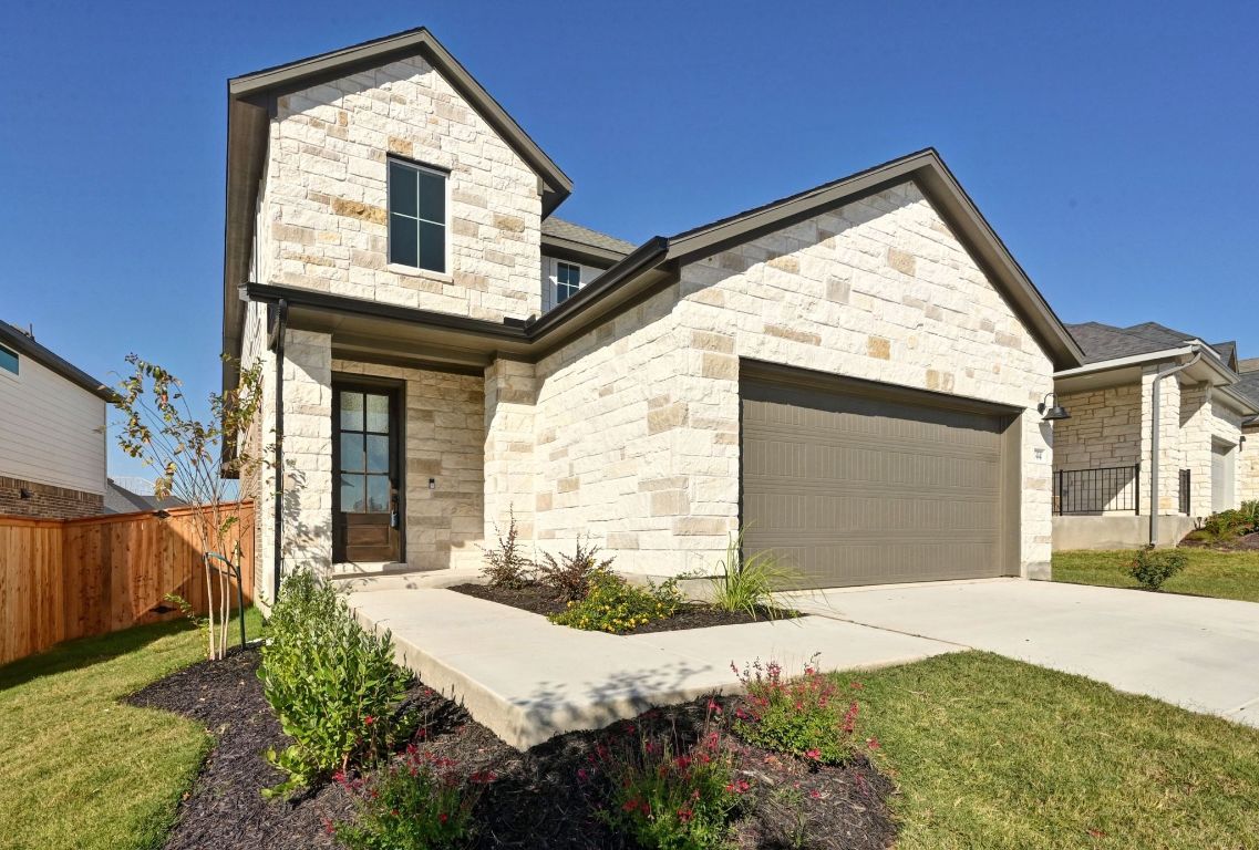 144 Granit Oak Drive Dripping Springs, TX 78620 - Photo 2 of 33 a front view of a house with a yard