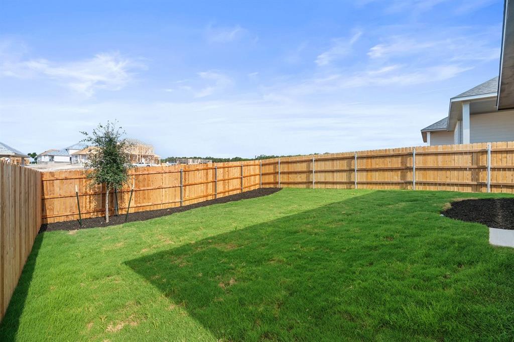 144 Granit Oak Drive Dripping Springs, TX 78620 - Photo 24 of 33 a view of an outdoor space and a yard