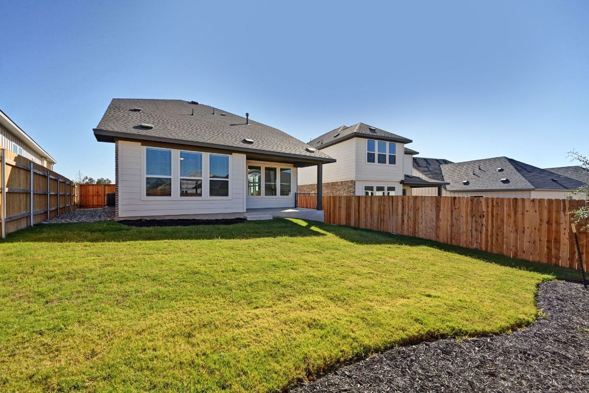 144 Granit Oak Drive Dripping Springs, TX 78620 - Photo 25 of 33 a front view of a house with a yard