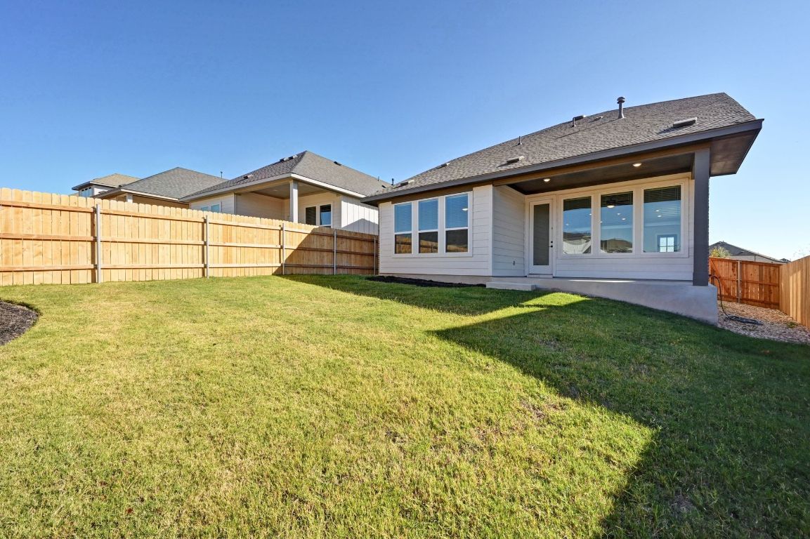 144 Granit Oak Drive Dripping Springs, TX 78620 - Photo 26 of 33 a front view of a house with a yard