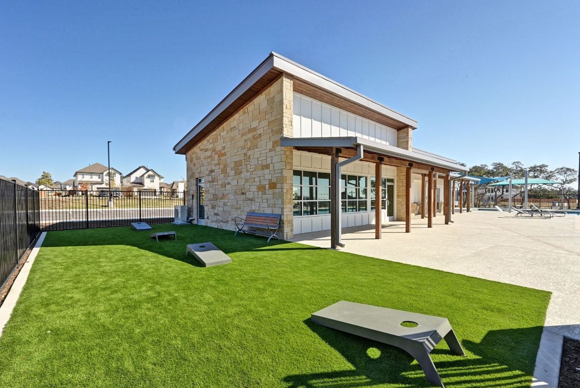144 Granit Oak Drive Dripping Springs, TX 78620 - Photo 33 of 33 a view of an house with backyard porch and outdoor kitchen