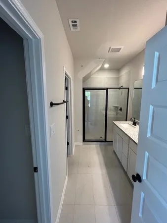 a bathroom with double sink and mirror