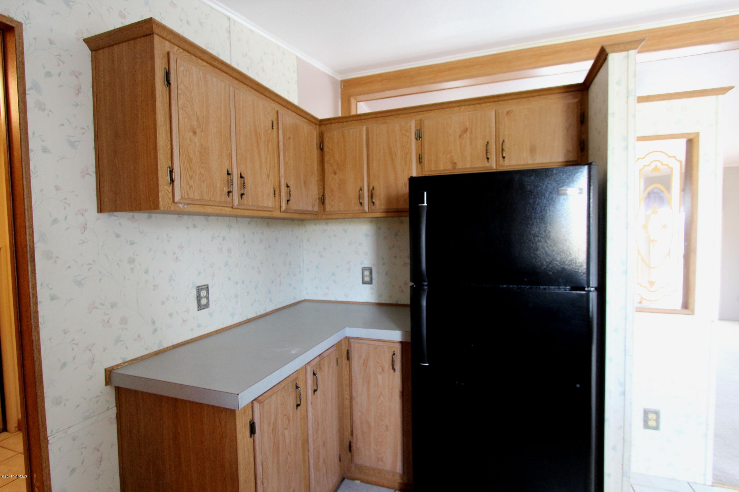 12381 Postma Road Moxee, WA 98936 - Photo 18 of 20 a kitchen with a sink and cabinets