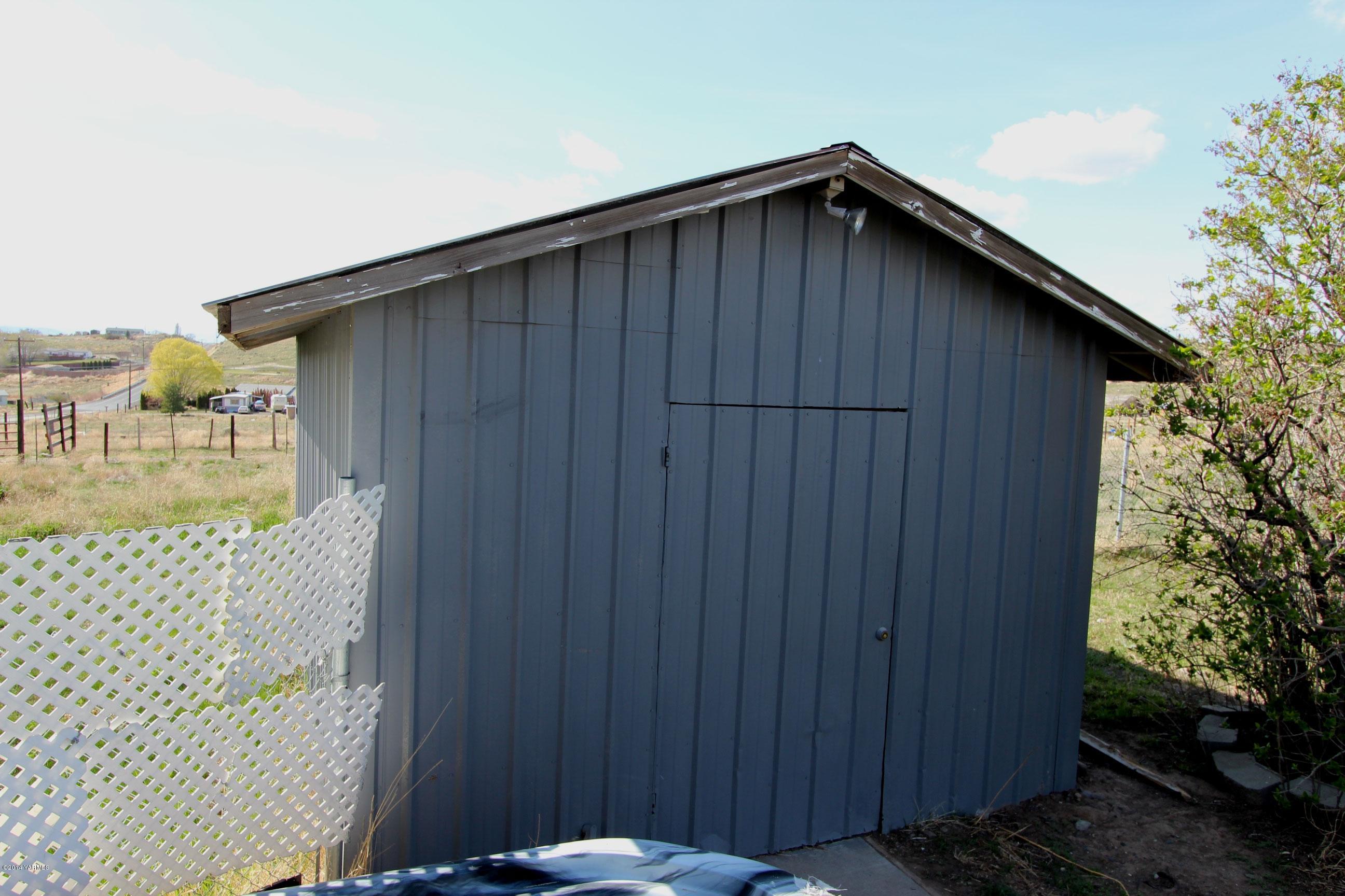 12381 Postma Road Moxee, WA 98936 - Photo 20 of 20 a wooden door in front of a house