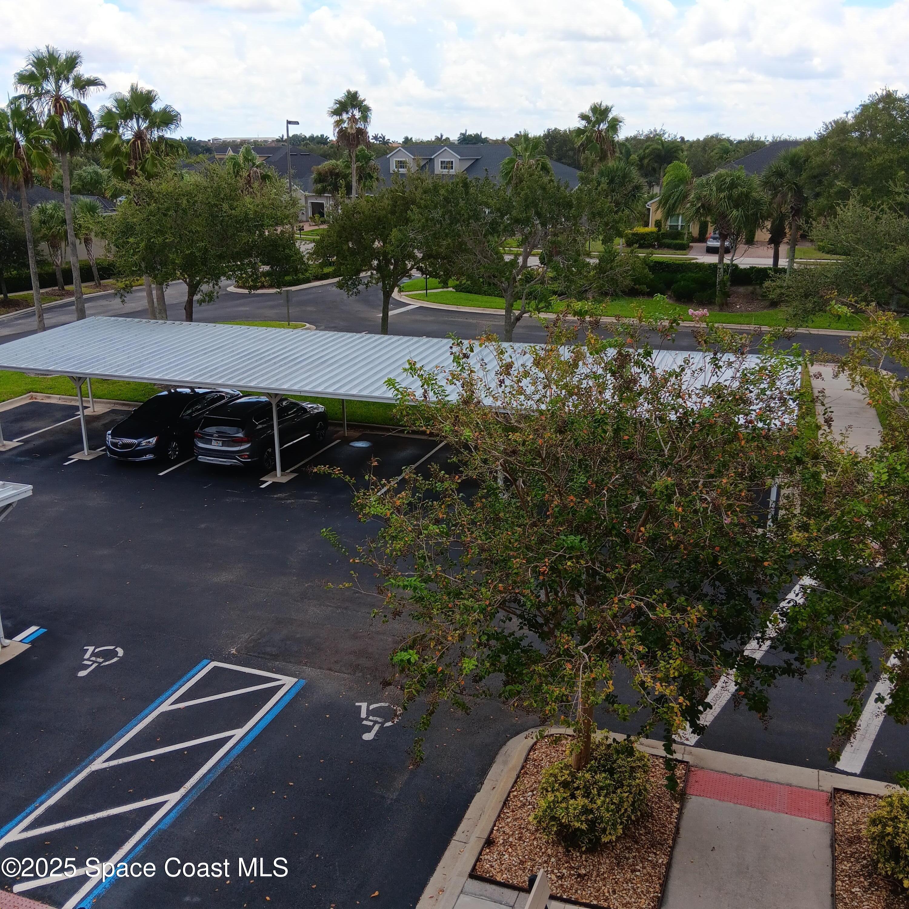 6858 Toland Drive, Unit 304 Melbourne, FL 32940 - Photo 27 of 31 a view of a tennis ground with large trees