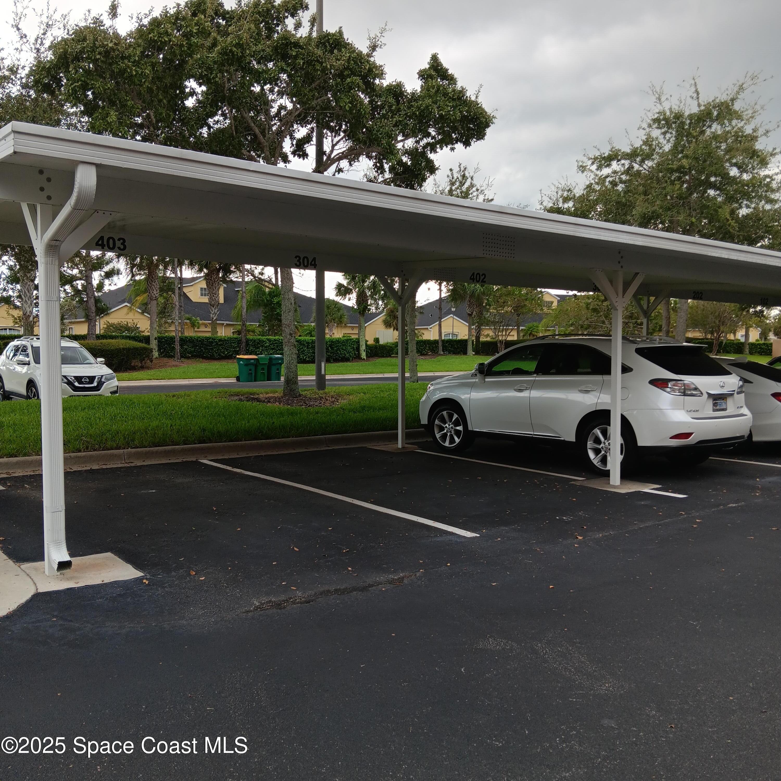 6858 Toland Drive, Unit 304 Melbourne, FL 32940 - Photo 29 of 31 a view of a car parked in front of a building