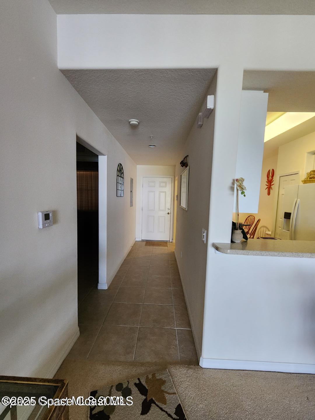6858 Toland Drive, Unit 304 Melbourne, FL 32940 - Photo 4 of 31 a view of a hallway with wooden floor and living room