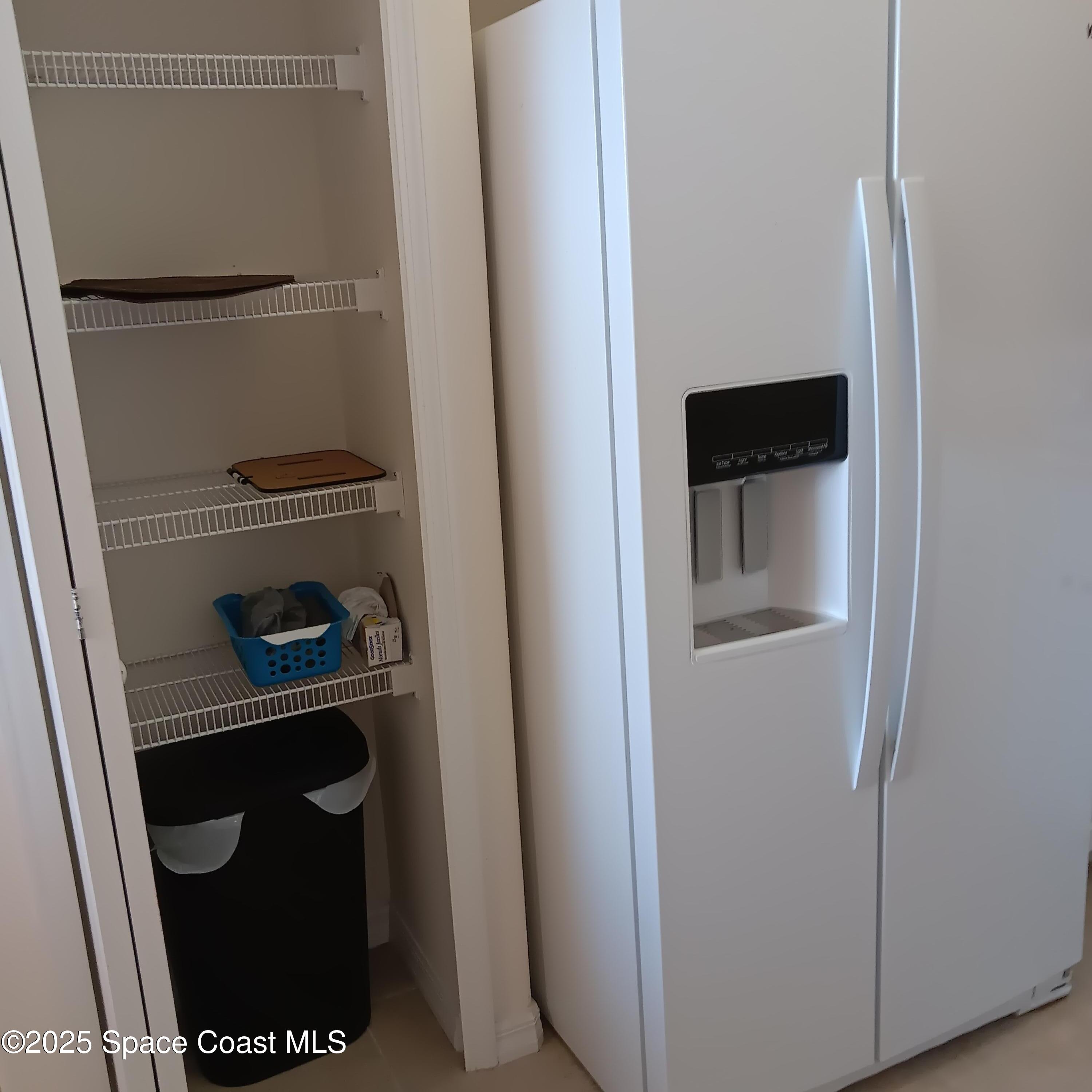 6858 Toland Drive, Unit 304 Melbourne, FL 32940 - Photo 5 of 31 a kitchen with a refrigerator and a stove