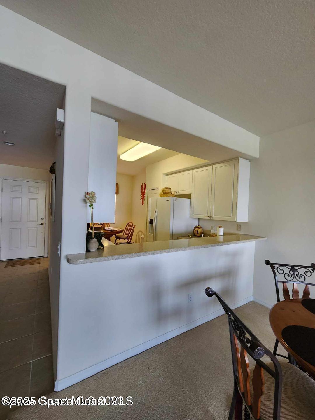 6858 Toland Drive, Unit 304 Melbourne, FL 32940 - Photo 7 of 31 a view of a kitchen with kitchen island and a sink