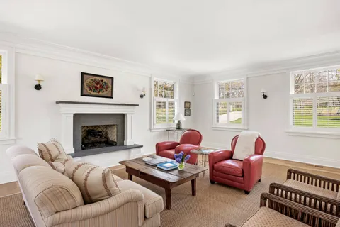a living room with furniture a rug and a fireplace