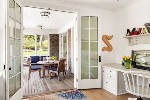 a dining room with furniture and wooden floor