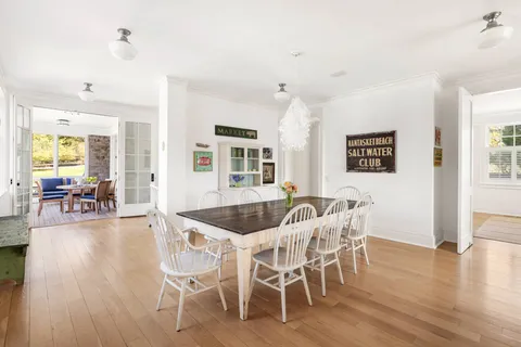 a dining room with kitchen island granite countertop furniture and a large window