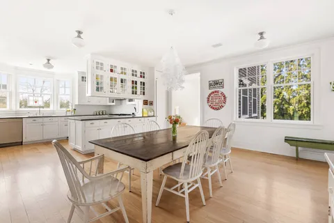 a dining room with furniture and wooden floor