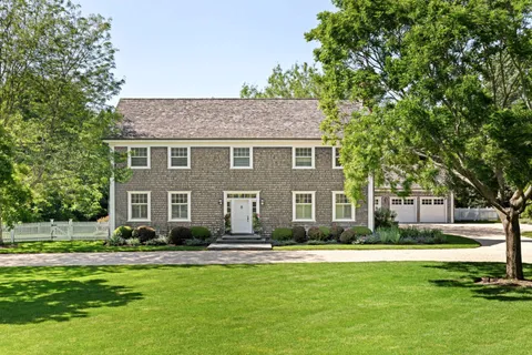 a front view of house with yard and green space