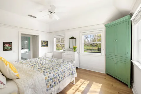 a bedroom with a large bed and a chandelier