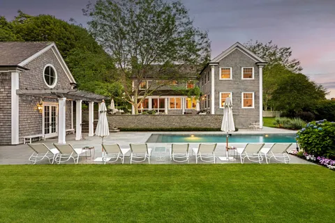 a front view of a house with a yard table and chairs