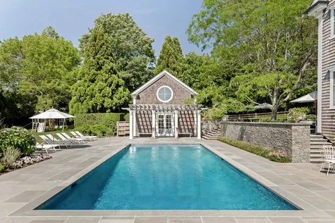 a view of a house with a yard and plants