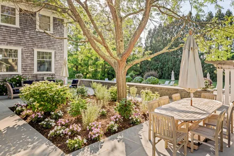 a view of an chairs and table in the backyard