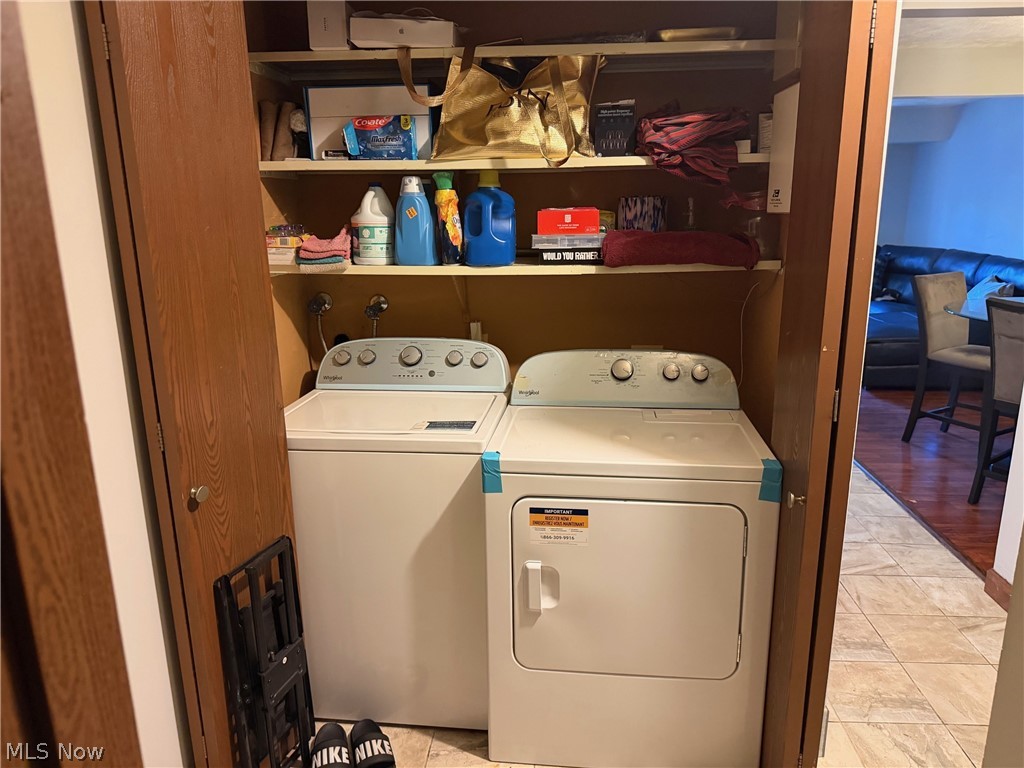 3249 Mayfield Road, Unit 13 Cleveland Heights, OH 44118 - Photo 6 of 7 Laundry closet featuring a white top-load washer and a white electric dryer
